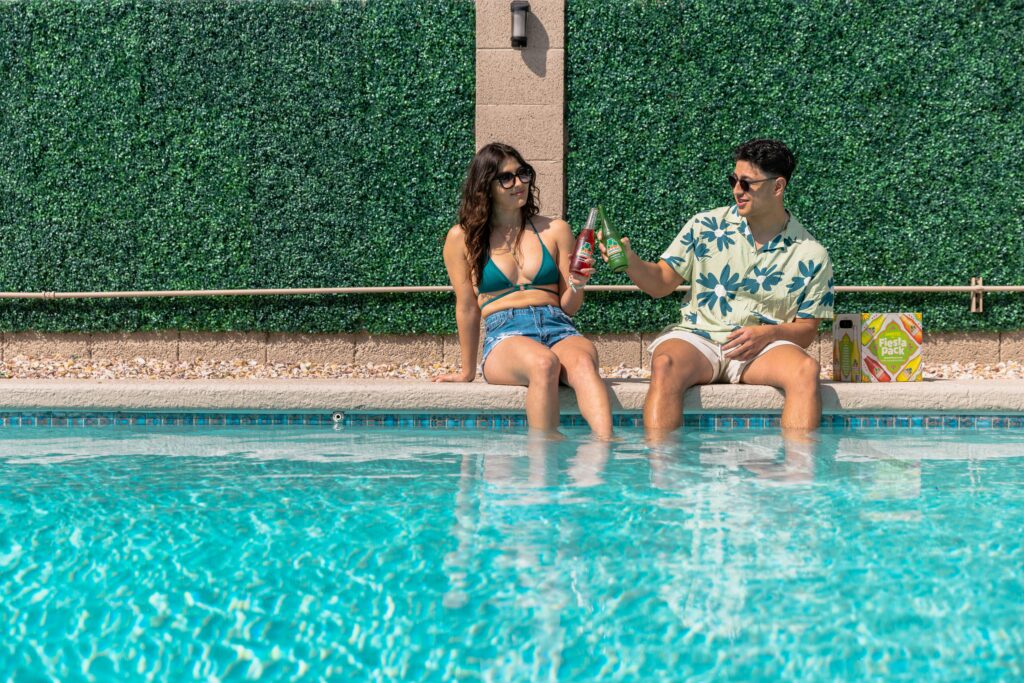 Couple relaxing by the pool at ARRIVE Palm Springs